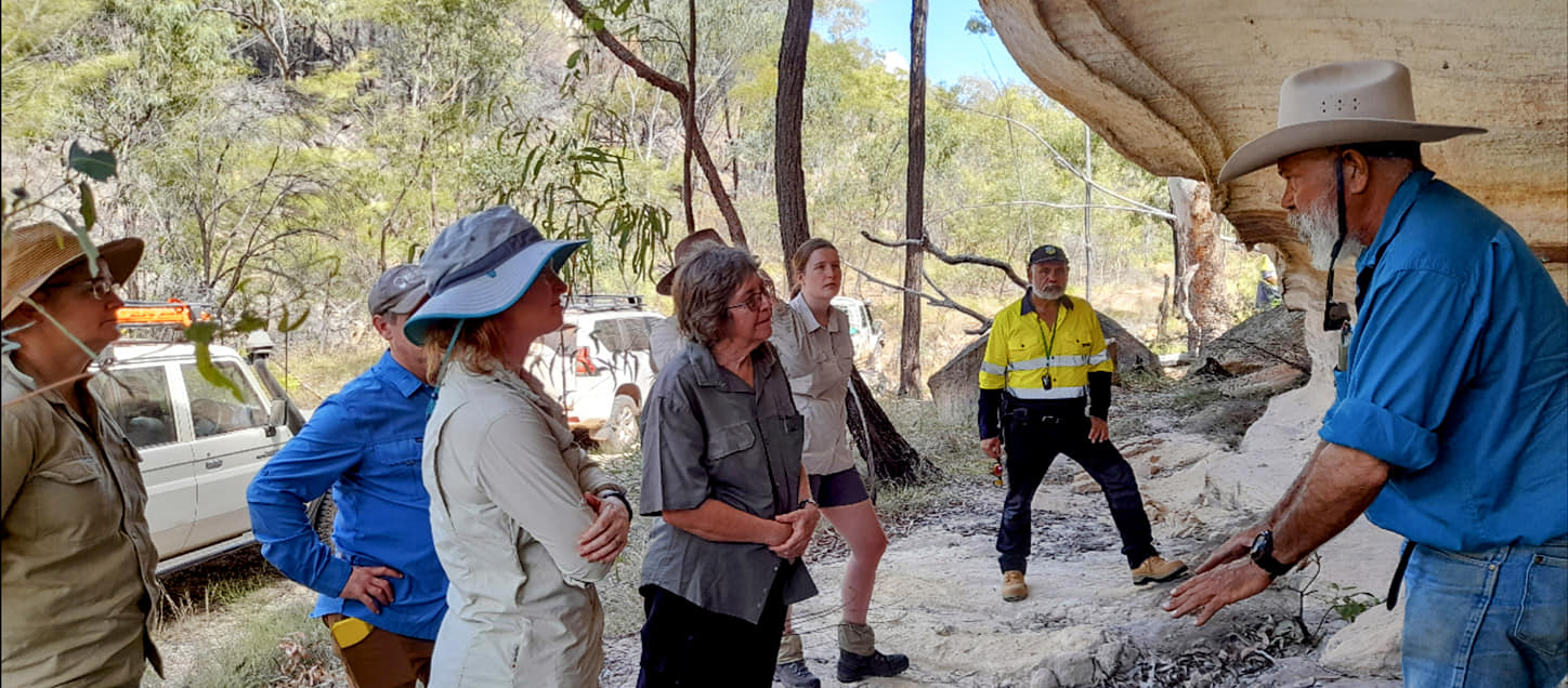 Scientists listening to a Traditional Owner sharing his knowledge