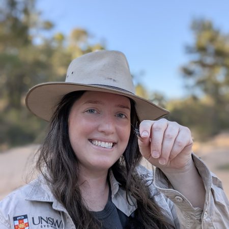 Entomologist Maya Darby holding a prized stinkbug