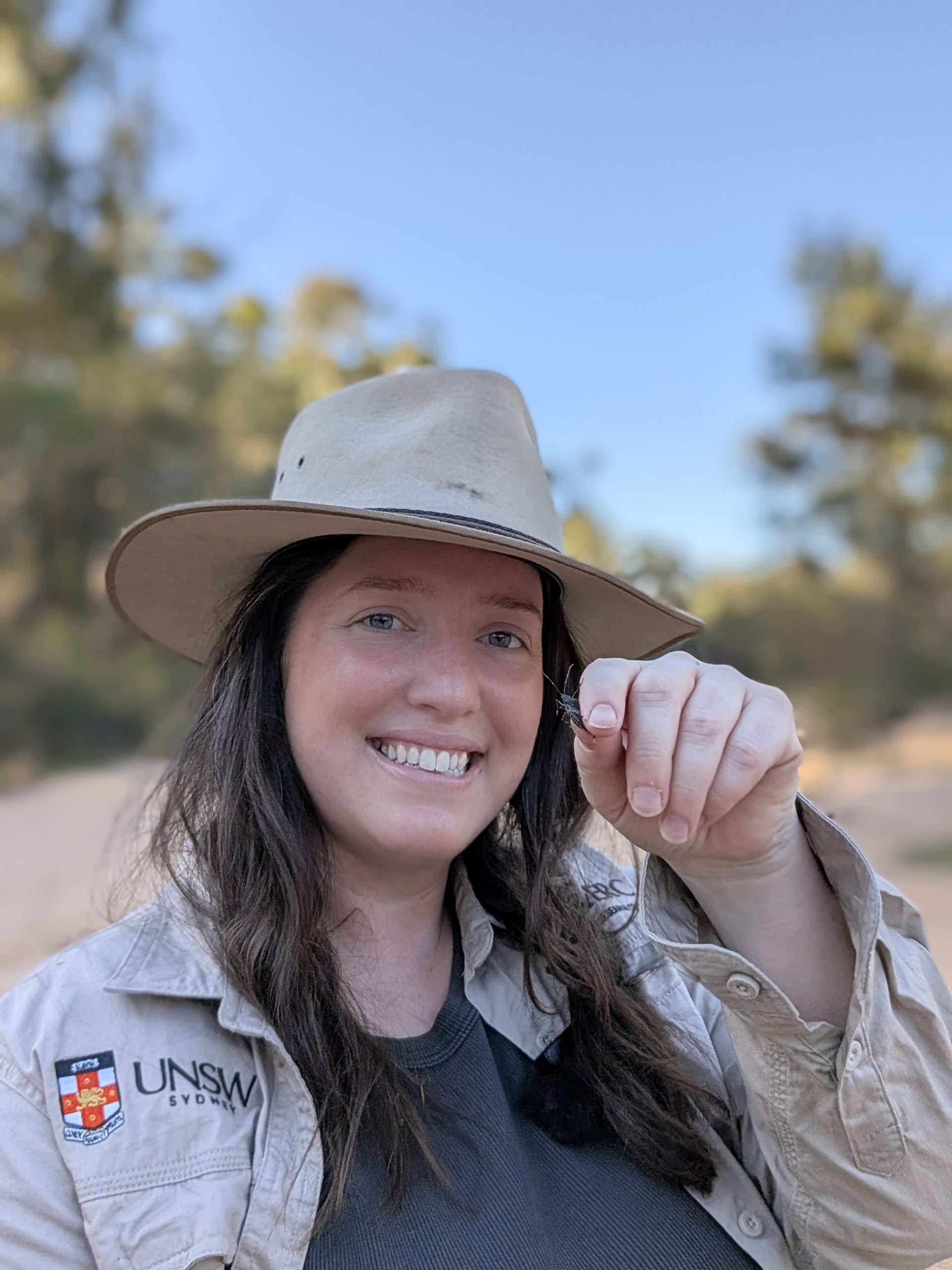 Entomologist Maya Darby holding a prized stinkbug